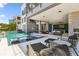 A spacious outdoor lounge with a full kitchen and cozy seating provides a relaxing space next to the pool at 4333 Harborpointe Dr, Port Richey, FL 34668