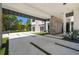 Elegant porte cochere leading to a modern home with a multi-car garage, surrounded by lush landscaping at 4333 Harborpointe Dr, Port Richey, FL 34668