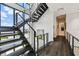Modern staircase features wooden steps, steel railings, and abundant natural light at 4333 Harborpointe Dr, Port Richey, FL 34668