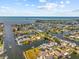 Aerial view of a waterfront home nestled in a beautiful canal community with stunning ocean views at 4387 6Th Isle Dr, Hernando Beach, FL 34607
