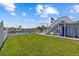 Backyard lawn overlooking a calm channel, with boat dock, and a staircase to a deck at 4387 6Th Isle Dr, Hernando Beach, FL 34607
