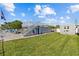 Backyard featuring a lush lawn, a staircase leading to a deck, and a shed for extra storage at 4387 6Th Isle Dr, Hernando Beach, FL 34607