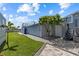 This backyard features a basketball hoop, palm tree, and plenty of paved walkway at 4387 6Th Isle Dr, Hernando Beach, FL 34607