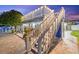 Backyard showcasing a staircase leading to an upper deck and a covered patio with outdoor furniture at 4387 6Th Isle Dr, Hernando Beach, FL 34607