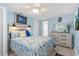 Bright bedroom featuring a beachy headboard with sconces, dresser, and coastal-themed decor at 4387 6Th Isle Dr, Hernando Beach, FL 34607