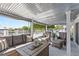 Spacious covered patio with comfortable seating, ideal for outdoor lounging with a view of the canal and backyard at 4387 6Th Isle Dr, Hernando Beach, FL 34607