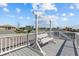 Second story deck with a swing bench, offering relaxing outdoor space and neighborhood views at 4387 6Th Isle Dr, Hernando Beach, FL 34607