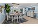 Sunlit dining area featuring coastal decor, modern lighting, and open concept design at 4387 6Th Isle Dr, Hernando Beach, FL 34607