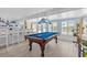 Well-lit game room featuring a beautiful billiards table, a bar, and large windows at 4387 6Th Isle Dr, Hernando Beach, FL 34607