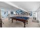 A game room features a pool table, bar seating, and an opening to a living area with nautical-themed decor at 4387 6Th Isle Dr, Hernando Beach, FL 34607