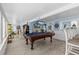 Game room with a pool table, nautical decor, seating, and an opening to a living area with a bar at 4387 6Th Isle Dr, Hernando Beach, FL 34607