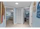 Hallway with doors leading to rooms, closet, and coastal decor, guiding you through the space at 4387 6Th Isle Dr, Hernando Beach, FL 34607