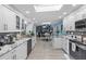 Bright kitchen featuring white cabinets, granite counters, modern appliances and an opening to the adjacent dining area at 4387 6Th Isle Dr, Hernando Beach, FL 34607