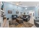 Bright and airy living room with comfortable seating, a fireplace, a decorative rug, and an opening to the kitchen at 4387 6Th Isle Dr, Hernando Beach, FL 34607