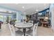 A dining room features a round table and adjoins an open-concept living room with a fireplace, TV, and built-in shelving at 4387 6Th Isle Dr, Hernando Beach, FL 34607