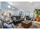 Open living room featuring comfortable sofas, a fireplace, built-in shelves, and ample natural light at 4387 6Th Isle Dr, Hernando Beach, FL 34607