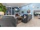 Cozy living room featuring a fireplace, TV, built-in shelving, sleek sofas and coastal-themed decor at 4387 6Th Isle Dr, Hernando Beach, FL 34607