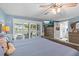 This main bedroom offers great natural light, ceiling fan, and a view to the bathroom at 4387 6Th Isle Dr, Hernando Beach, FL 34607