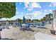 Outdoor patio with dining and lounge seating overlooks the waterfront with the beautiful pool nearby at 4387 6Th Isle Dr, Hernando Beach, FL 34607