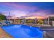 Relaxing pool area with lounge chairs and waterfront views. Enjoy the pool slide with a view of the sunset at 4387 6Th Isle Dr, Hernando Beach, FL 34607