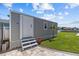 Outdoor view of shed with neutral paint, stairs to a door, and a small palm tree at 4387 6Th Isle Dr, Hernando Beach, FL 34607