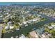Wide aerial shot of a waterfront community with canals, docks, boats, and lush greenery at 4482 Kingston Dr, Hernando Beach, FL 34607