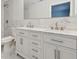 Bathroom featuring a double vanity with marble countertop and tile backsplash at 4482 Kingston Dr, Hernando Beach, FL 34607