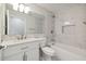Bright bathroom featuring marble tile, modern fixtures, and a white vanity, with a tub and shower combination at 4482 Kingston Dr, Hernando Beach, FL 34607