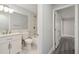 Bright bathroom featuring marble tile, modern fixtures, and a white vanity, with a tub and shower combination at 4482 Kingston Dr, Hernando Beach, FL 34607