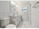Beautiful bathroom featuring marble tile walls, double vanity, and sleek fixtures at 4482 Kingston Dr, Hernando Beach, FL 34607