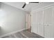 Bedroom with wood-look flooring, a ceiling fan, closet, and a white door leading to another room at 4482 Kingston Dr, Hernando Beach, FL 34607