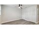 Bedroom featuring wood flooring, a ceiling fan, and closet doors at 4482 Kingston Dr, Hernando Beach, FL 34607