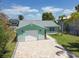 Aqua home featuring a paver driveway, a white garage door, and a well-maintained lawn at 4482 Kingston Dr, Hernando Beach, FL 34607