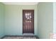 Close-up of a welcoming front door with glass panels and a modern lock, set against light green walls at 4482 Kingston Dr, Hernando Beach, FL 34607