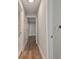 Hallway featuring wood-look flooring, white walls, and doorways leading to the bathroom and bedroom at 4482 Kingston Dr, Hernando Beach, FL 34607