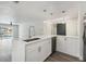 Bright kitchen featuring a large island with white countertops and a barn door in the background at 4482 Kingston Dr, Hernando Beach, FL 34607