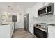 Modern kitchen with stainless steel appliances, white cabinetry and subway tile backsplash at 4482 Kingston Dr, Hernando Beach, FL 34607
