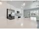 Close up of updated kitchen with white cabinets, gray backsplash, and stainless steel appliances at 4482 Kingston Dr, Hernando Beach, FL 34607