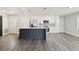 Updated kitchen with white cabinets, gray backsplash, a quartz island, and stainless steel appliances at 4482 Kingston Dr, Hernando Beach, FL 34607