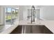 Modern kitchen island featuring a stainless steel sink, faucet, and countertops at 4482 Kingston Dr, Hernando Beach, FL 34607