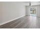 Bright living room with water view, ceiling fan, and sleek gray flooring at 4482 Kingston Dr, Hernando Beach, FL 34607
