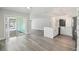 Open-concept living room with sliding glass doors to the pool and an updated kitchen with stainless steel appliances at 4482 Kingston Dr, Hernando Beach, FL 34607