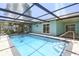 Inviting screened pool area with pavers and sparkling water, perfect for relaxation and entertaining at 4482 Kingston Dr, Hernando Beach, FL 34607