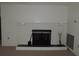Close-up view of a classic white brick fireplace with a black metal screen and decorative hearth at 4529 Keelboat Pl, New Port Richey, FL 34652