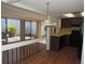Open-concept kitchen featuring laminate floors, a pass-through to the sunroom, and modern appliances at 4529 Keelboat Pl, New Port Richey, FL 34652