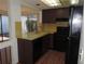 Compact kitchen with laminate floors, laminate countertops, and modern appliances for efficient cooking at 4529 Keelboat Pl, New Port Richey, FL 34652