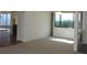 Bright living room with a large window, plush carpet, and an open layout leading into the kitchen at 4529 Keelboat Pl, New Port Richey, FL 34652