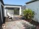 Private outdoor patio with wood deck, pavers, privacy walls, and sunny seating at 4529 Keelboat Pl, New Port Richey, FL 34652