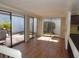 Bright sunroom with laminate floors, multiple sliding glass doors, and scenic views of the backyard at 4529 Keelboat Pl, New Port Richey, FL 34652
