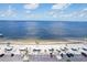 Aerial view of a serene beach with pavilions, palm trees, and parking at 4942 Blue Heron Dr, New Port Richey, FL 34652